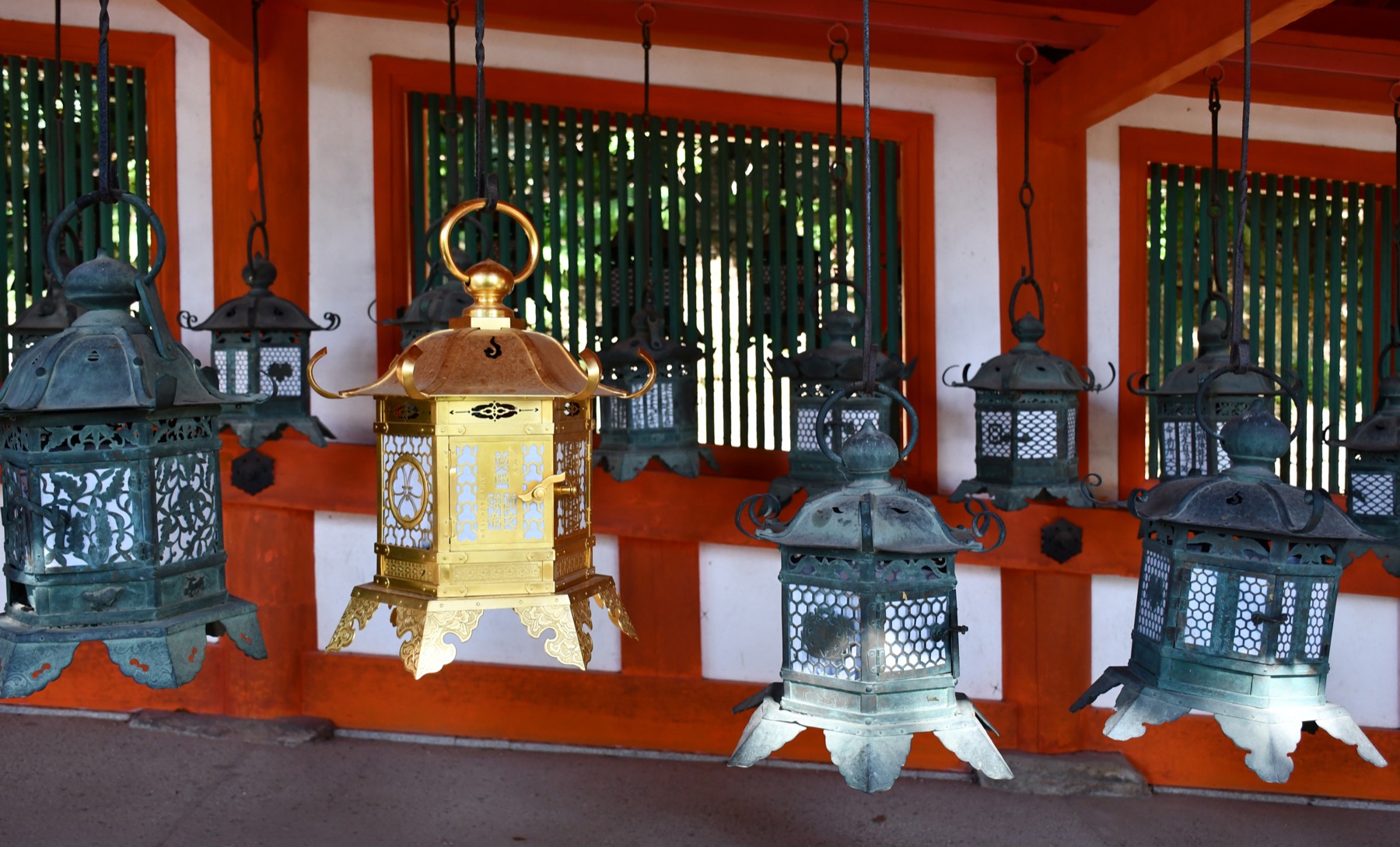 Rows of bronze lanterns hanging inside the Kasugataisha cloister